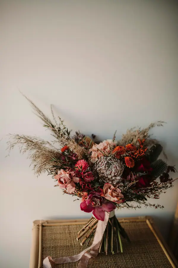 Dried-tone bouquet with burgundy and blush flowers